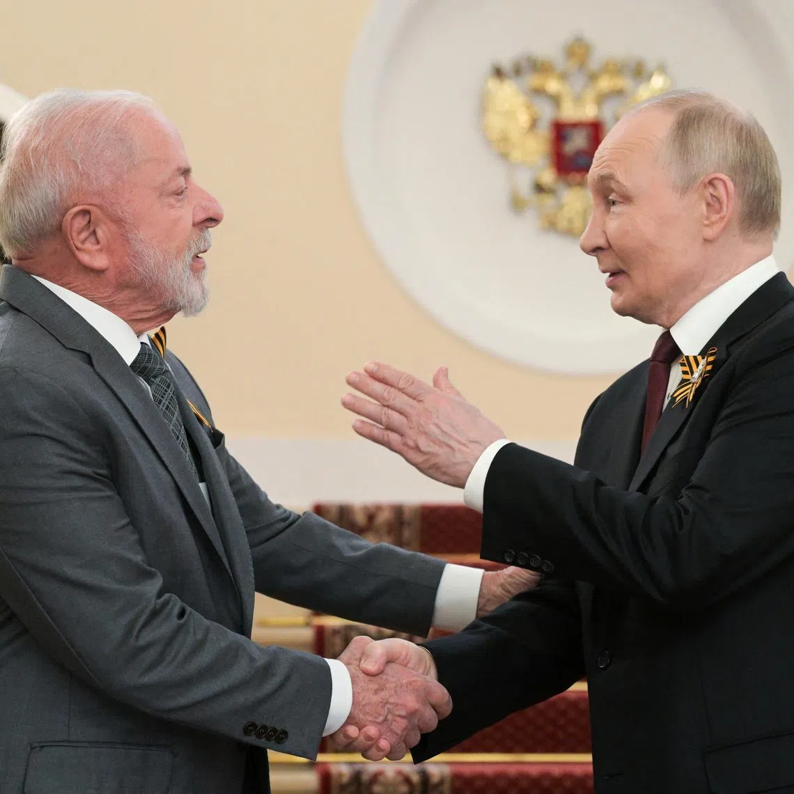 FILE PHOTO: Russian President Vladimir Putin greets Brazilian President Luiz Inacio Lula da Silva before a military parade on Victory Day, marking the 80th anniversary of the victory over Nazi Germany in World War Two, in Moscow, Russia, May 9, 2025. Alexei Nikolsky/Host agency RIA Novosti/Handout via REUTERS/File Photo