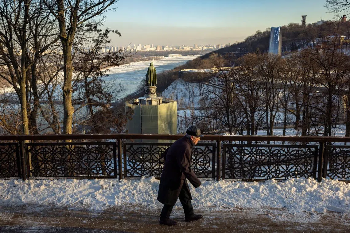 FILE PHOTO: A man walks in a park overlooking Dnipro River on a sunny winter day in Kyiv, amid Russia’s attack on Ukraine, January 17, 2024. REUTERS/Thomas Peter/File Photo