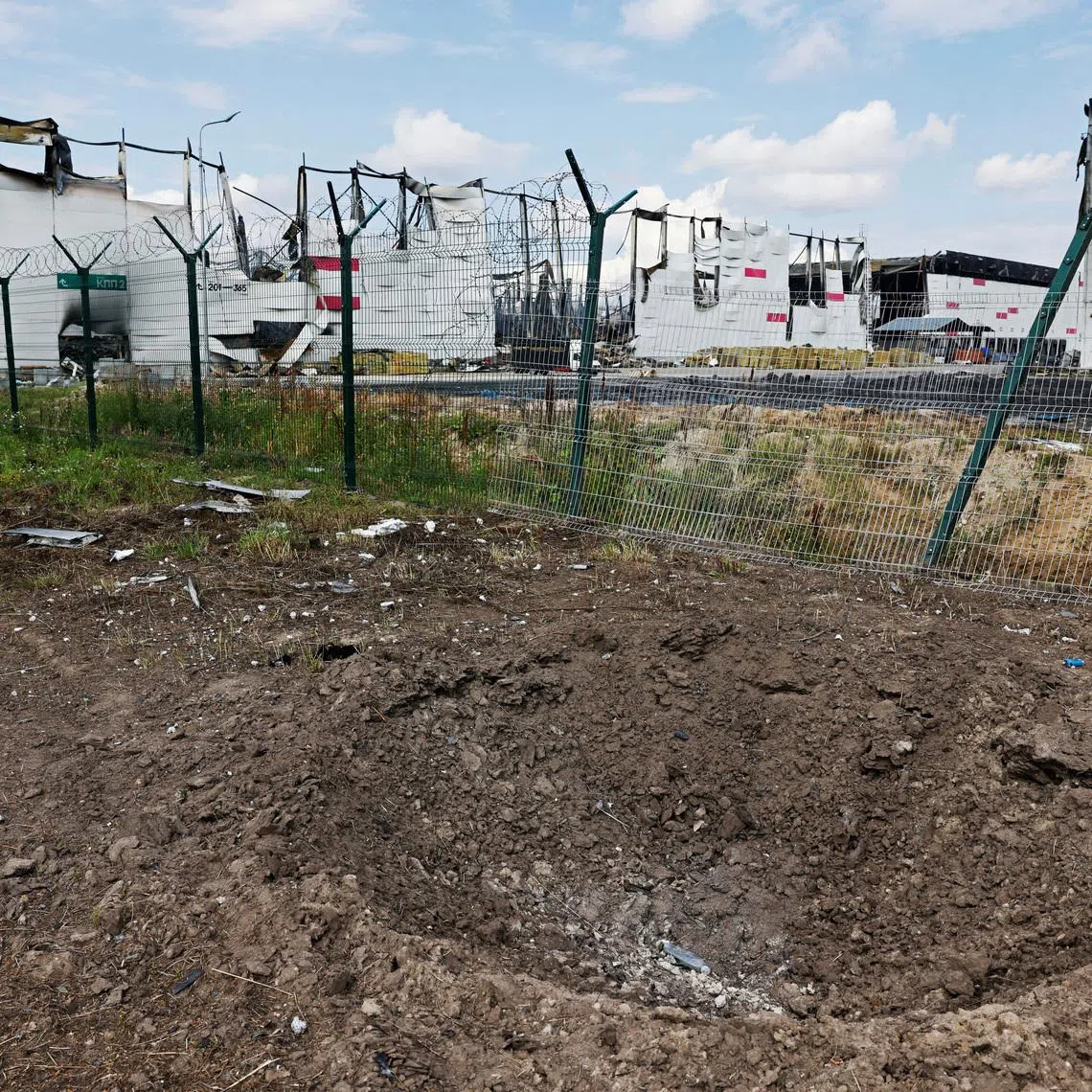 A crater near the remains of the Wildberries warehouse that burned down after a recent Ukrainian drone attack in the course of the Russia-Ukraine conflict, in the city of Elektrostal in the Moscow region, Russia July 23, 2026. REUTERS/Stringer
