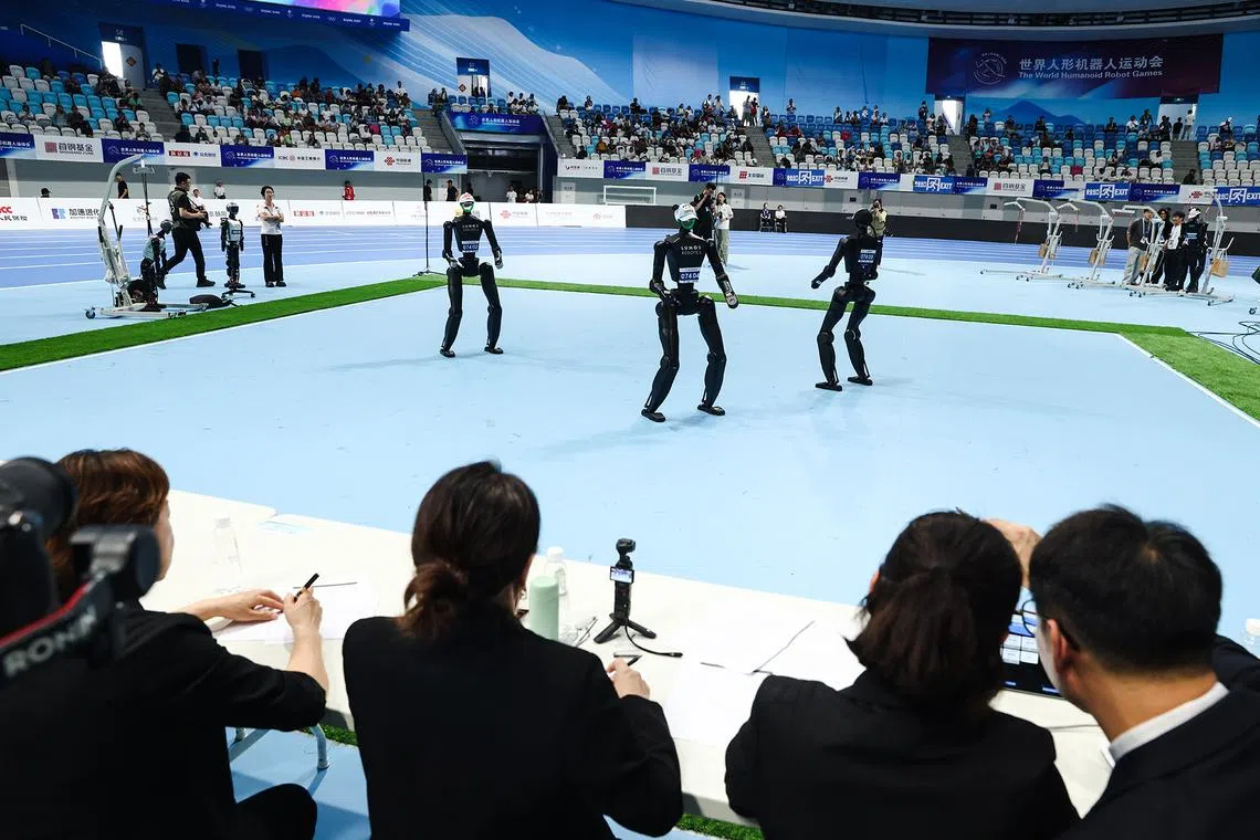 Humanoid robots dancing during the World Humanoid Robot Games at the National Speed Skating Oval in Beijing, China, on Aug 15, 2025. 