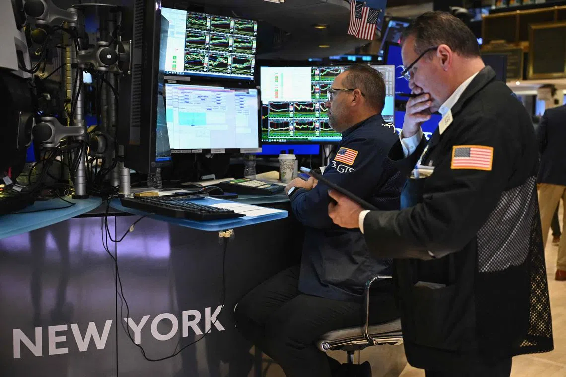 Traders work on the floor of the New York Stock Exchange, in New York City. 