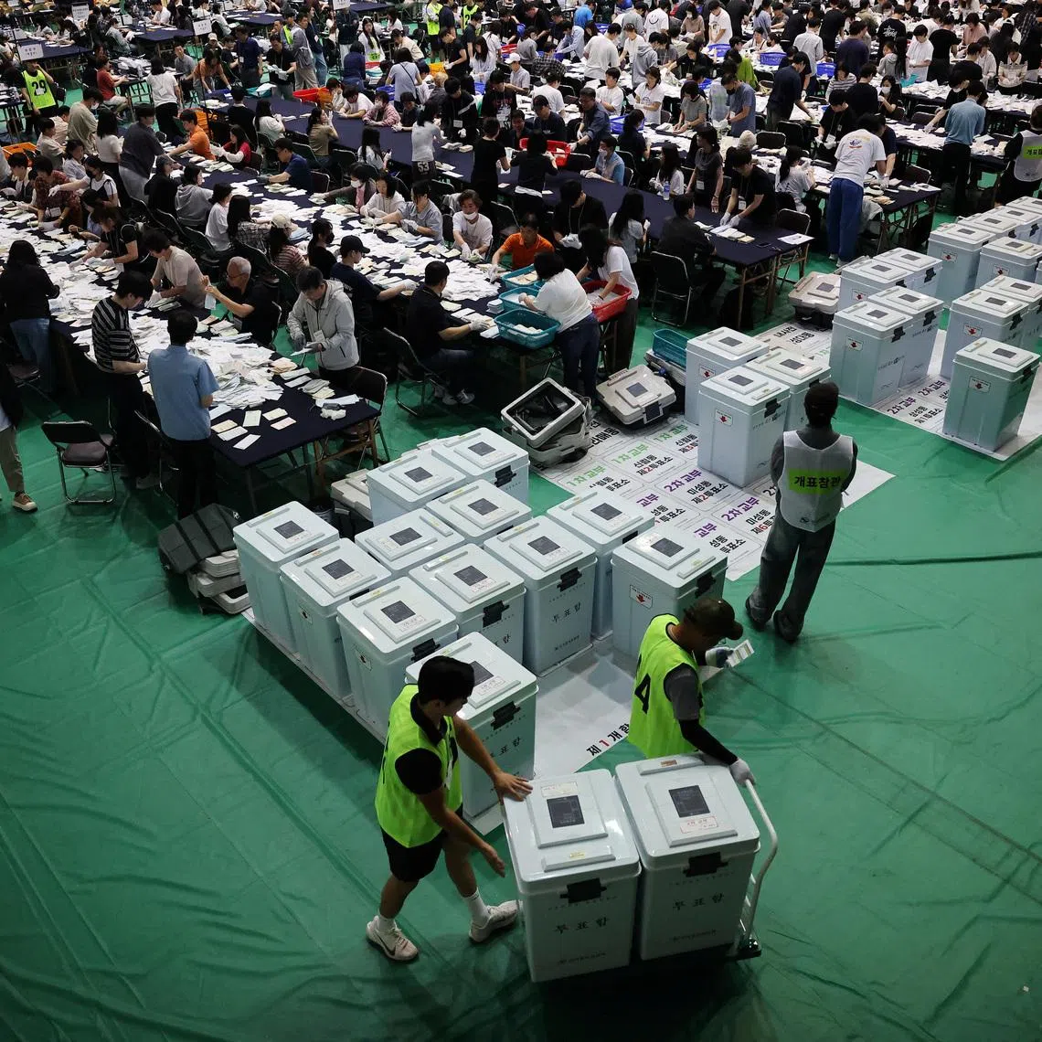 Election officials carrying the ballots for local elections arrive at a counting centre in Seoul on June 3.