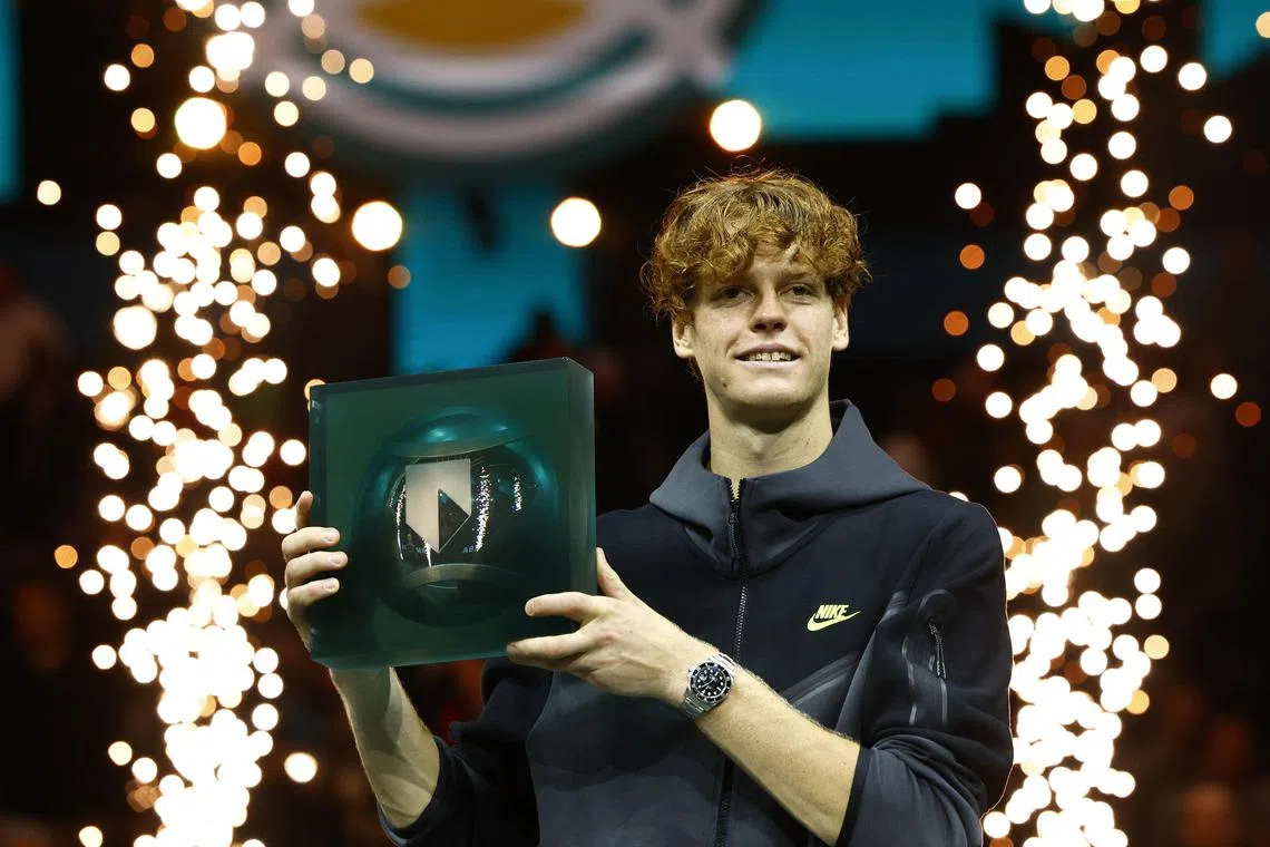Italy's Jannik Sinner celebrates with the Rotterdam Open trophy after winning the final against Australia's Alex de Minaur.