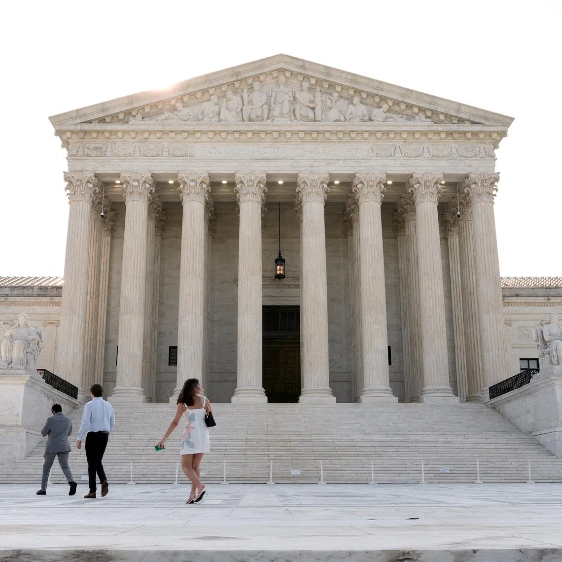 People walk in front of the Supreme Court building, as the court is set to issue the final rulings of its nine-month term, in Washington, D.C., U.S., June 30, 2026. REUTERS/Cheney Orr