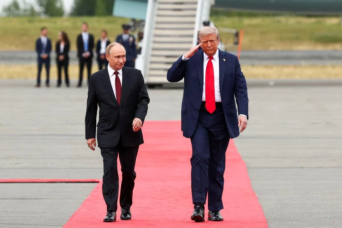 U.S. President Donald Trump walks with Russian President Vladimir Putin, as they meet to negotiate for an end to the war in Ukraine, at Joint Base Elmendorf-Richardson in Anchorage, Alaska, U.S., August 15, 2025. REUTERS/Kevin Lamarque