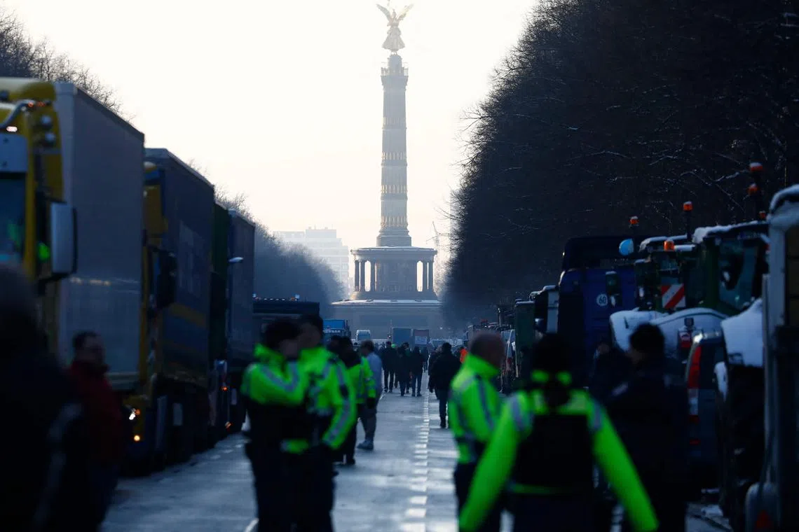 Trucks stand in line during a protest of truck drivers at victory column in Berlin, Germany on January 18, 2024. Truck drivers protest against the double burden of the CO2 tax and an increase in toll collections. (Photo by MICHELE TANTUSSI / AFP)