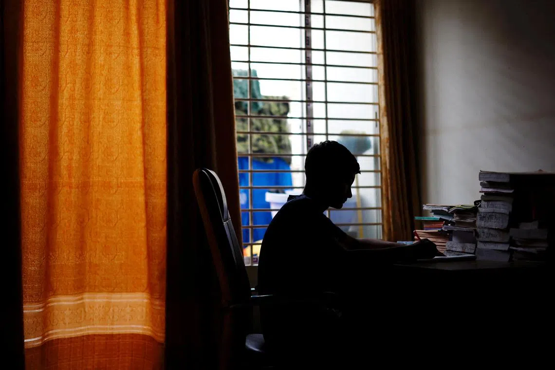 Sheikh Tamim Hasan, 13, a student of class seven, studies in his room as authorities decided to close schools during countrywide heatwave in Dhaka, Bangladesh, April 30, 2024. REUTERS/Mohammad Ponir Hossain