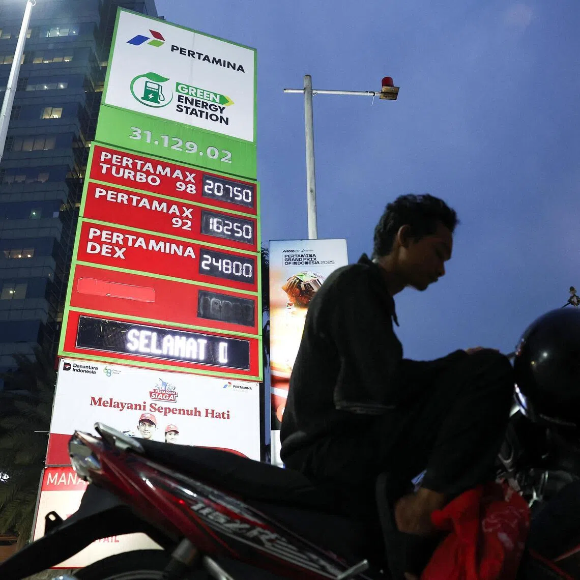 A man sits on his motorbike in front of a fuel station of Indonesian state firm Pertamina, as it has raised the price of its 92-octane gasoline, known as Pertamax and 95-octane gasoline, known as Pertamax Green, by around 32%, in Jakarta, Indonesia, June 10, 2026. REUTERS/Willy Kurniawan