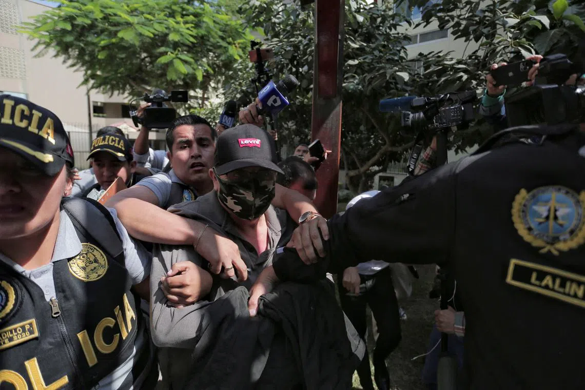 Police officers escort Nicanor Boluarte, brother of Peruvian President Dina Boluarte, as he leaves his home, after prosecutors detained him for allegedly being part of a group that trafficked influence, according to the Attorney General's Office, in Lima, Peru May 10, 2024. REUTERS/Gerardo Marin