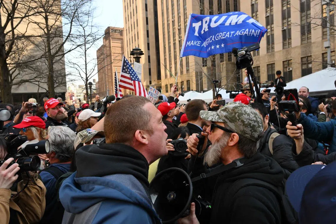 A supporter of Donald Trump argues with opponents outside the Manhattan District Attorney's office in New York City on April 4, 2023.