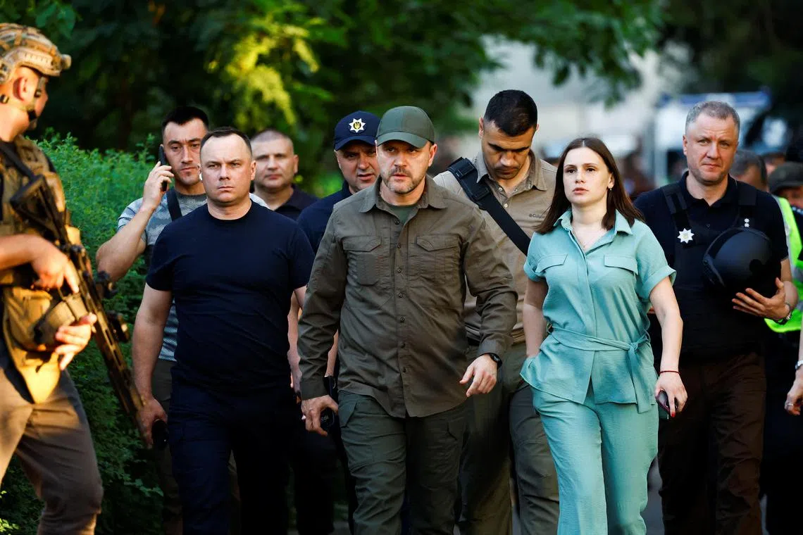 Ukraine’s Interior Minister Ihor Klymenko  (centre) said the suspect had locked himself into a bathroom and tossed an explosive device at two guards.