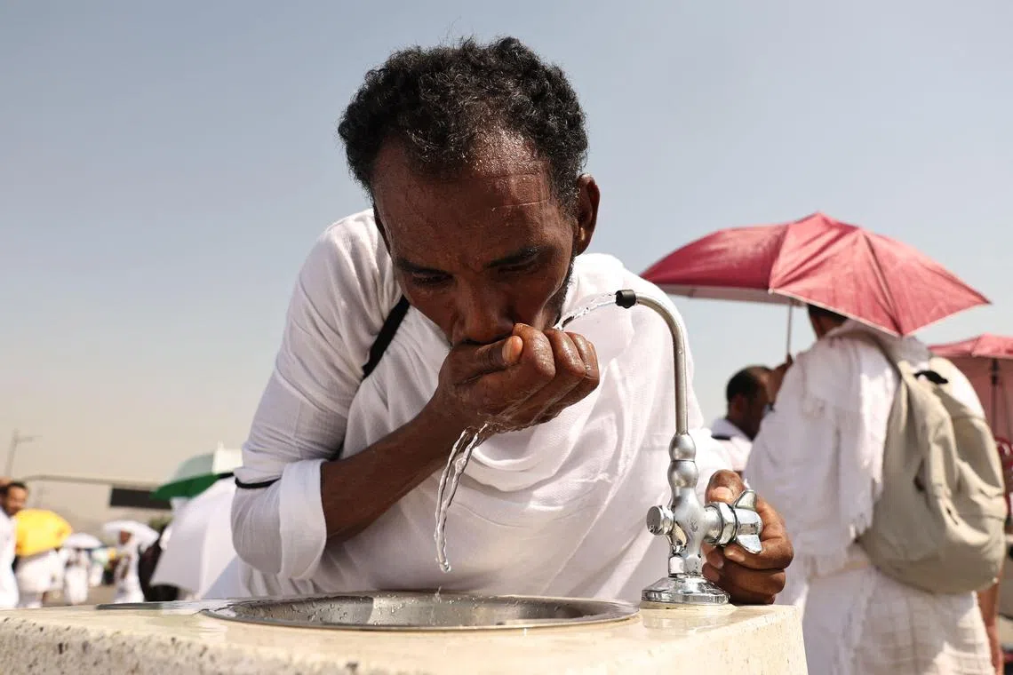 A pilgrim drinking from a water fountain at the base of Saudi Arabia's Mount Arafat, on June 15.