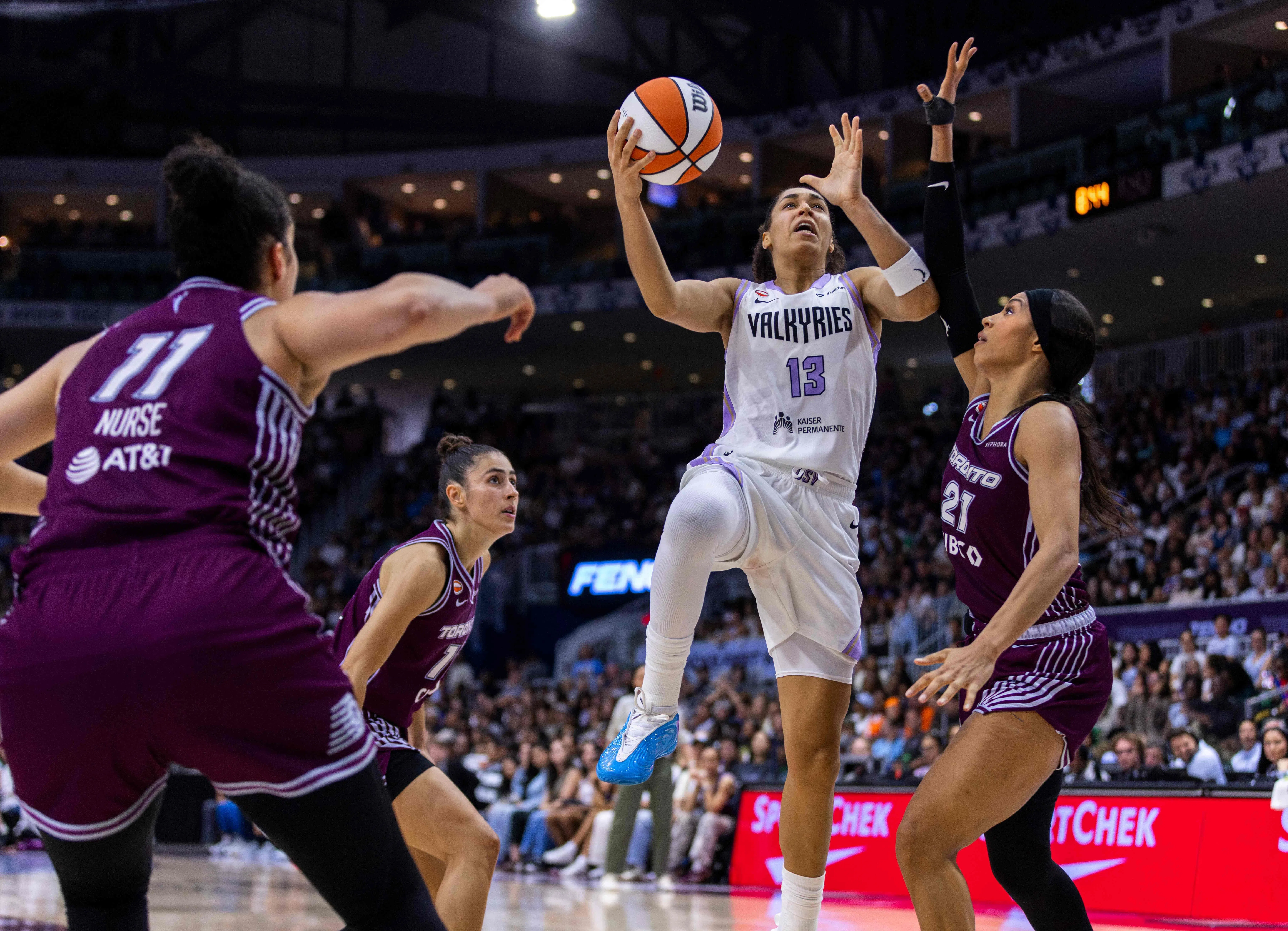TORONTO, CANADA - JULY 8: Janelle Salaun #13 of the Golden State Valkyries drives to the net while guarded by Isabelle Harrison #21 of the Toronto Tempo during the second half of a WNBA game at Coca-Cola Coliseum on July 8, 2026 in Toronto, Canada. NOTE TO USER: User expressly acknowledges and agrees that, by downloading and or using this photograph, User is consenting to the terms and conditions of the Getty Images License Agreement.   Tara Walton/Getty Images/AFP (Photo by Tara Walton / GETTY IMAGES NORTH AMERICA / Getty Images via AFP)