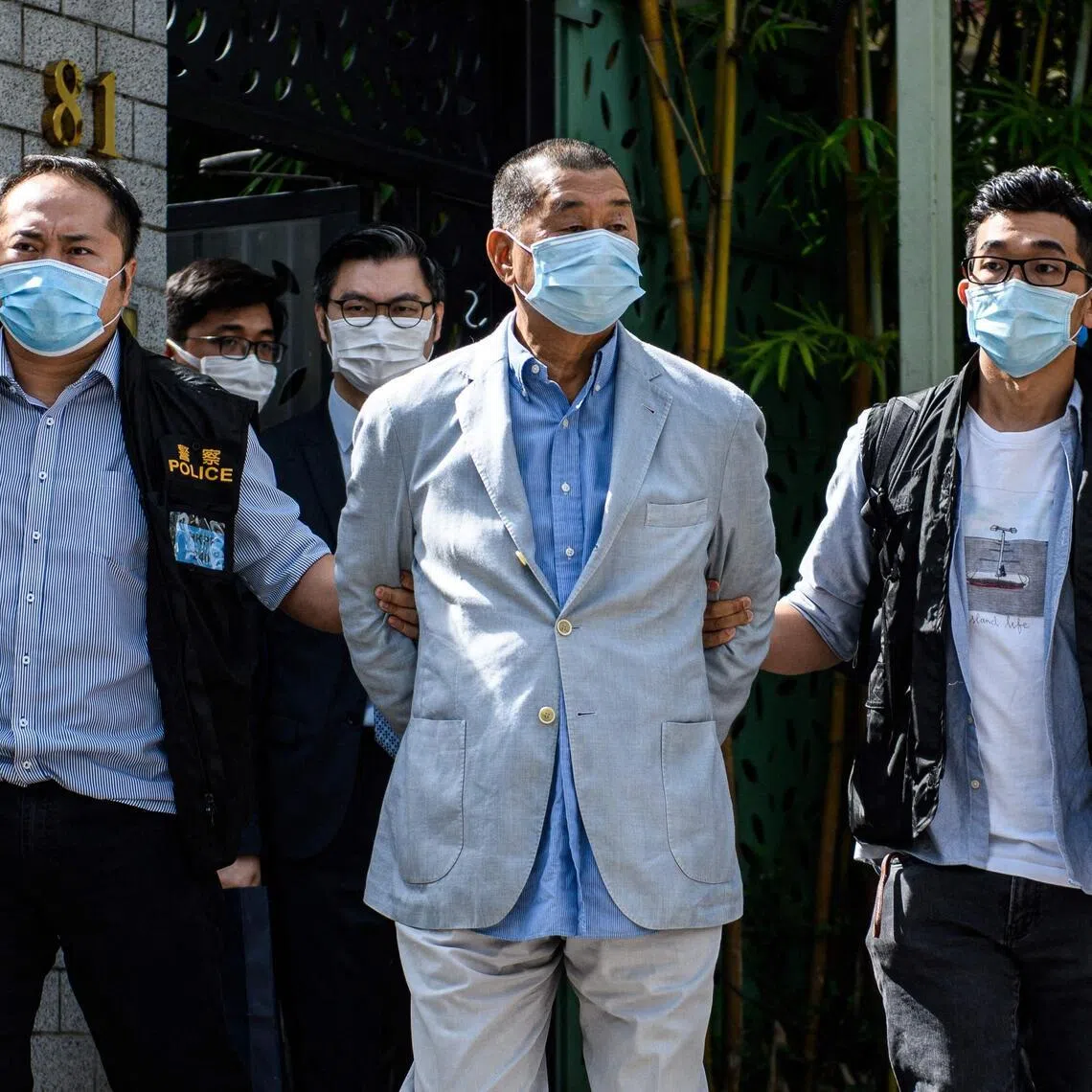 Police leading Jimmy Lai (centre) away from his home after he was arrested under the new national security law in Hong kong on Aug 10, 2020.