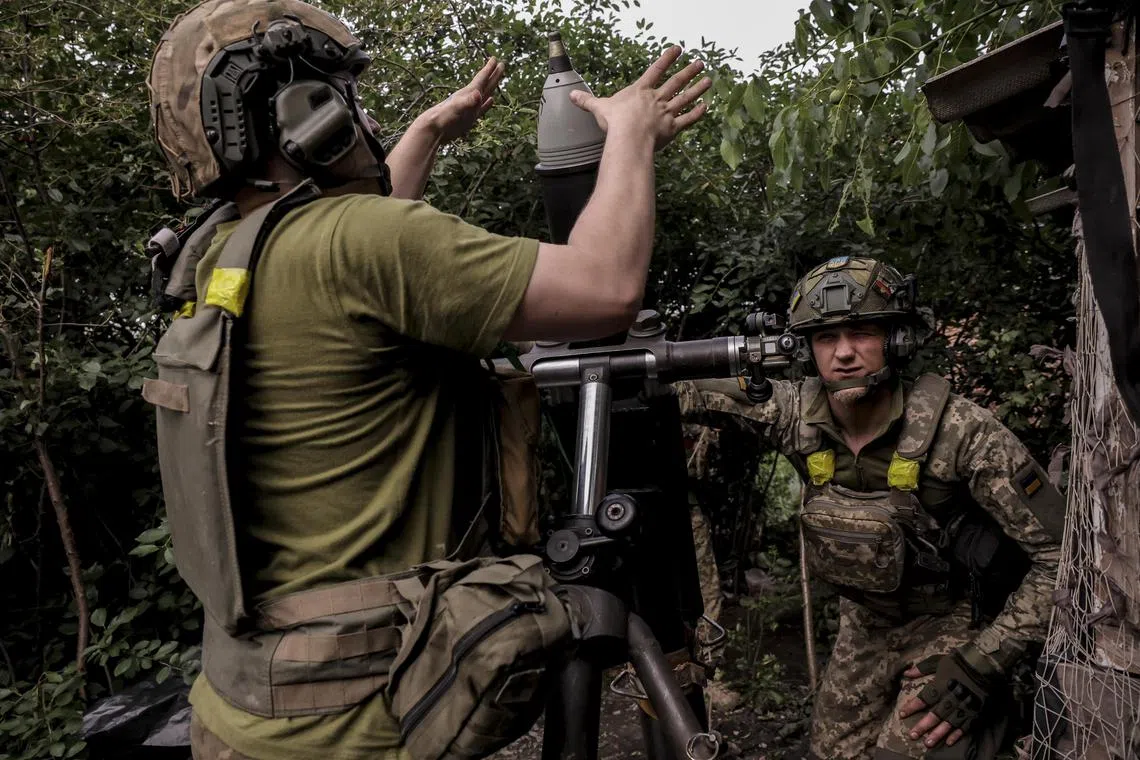 Ukrainian servicemen preparing to fire a mortar on the front line near Chasiv Yar, on June 15.