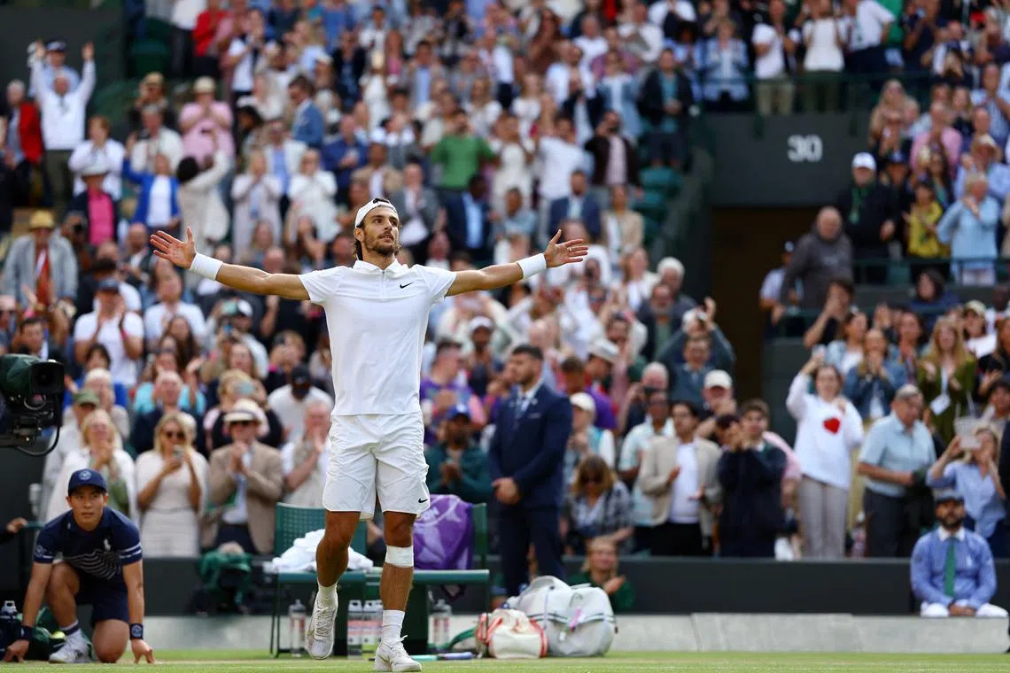 Tennis - Wimbledon - All England Lawn Tennis and Croquet Club, London, Britain - July 10, 2024 Italy's Lorenzo Musetti celebrates after winning his quarter final match against Taylor Fritz of the U.S. REUTERS/Hannah Mckay