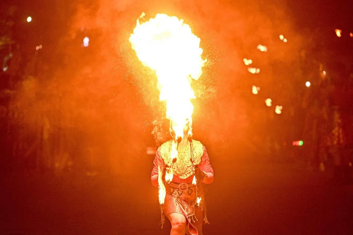 A fire breather performing during the Surabaya Vaganza street night parade, part of celebrations marking the 733rd anniversary of Surabaya, Indonesia's second largest city, on May 16, 2026. 