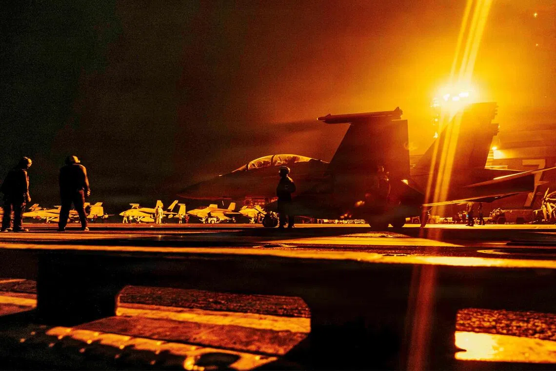An F/A-18 Super Hornet readies for takeoff on the flight deck of the Nimitz-class aircraft carrier USS George Washington.