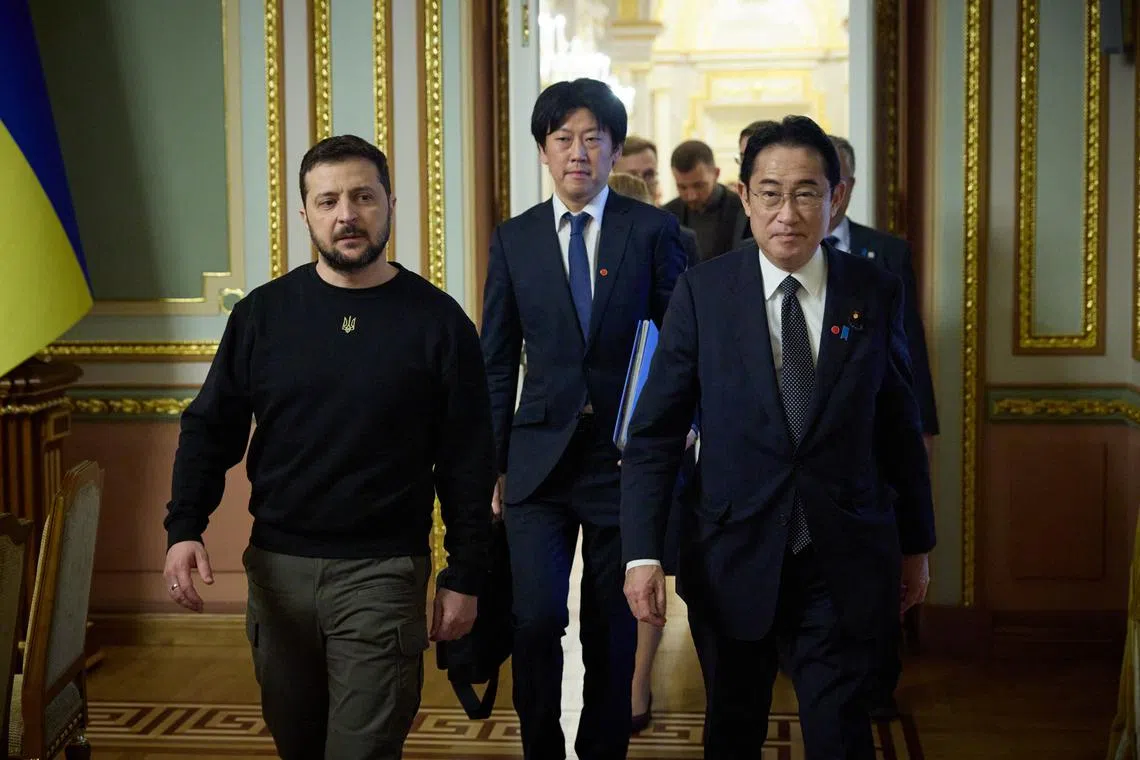 Ukraine President Volodymyr Zelensky (left) and Japan's PM Fumio Kishida arriving for a meeting at Mariinsky Palace in Kyiv on March 21.