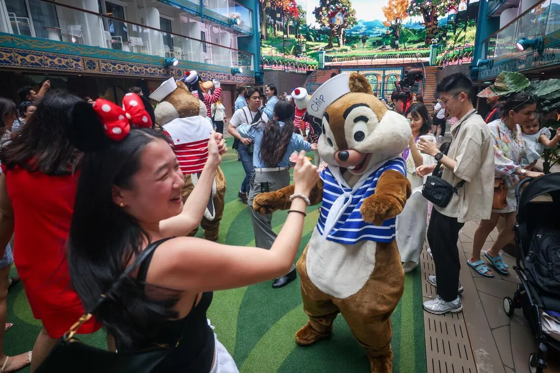 Disney characters dancing with guests onboard Disney Adventure cruise on March 5, 2026. The ship is Asia’s first Disney cruise and can carry up to 6,700 passengers. 