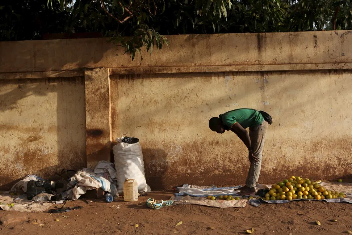 A fruit vendor prays on the side of a street in Bamako, Mali, April 11, 2016. REUTERS/Joe Penney/File Photo