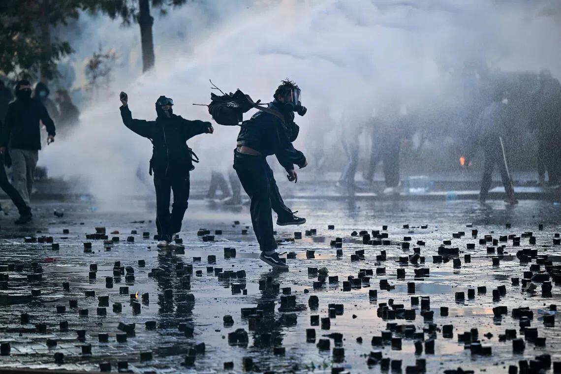 Protesters throw cobblestones during an anti-government demonstration in central Tirana on Oct 17.