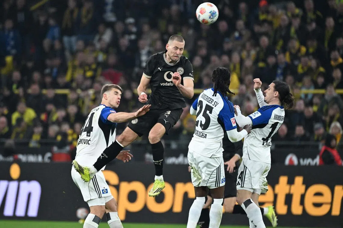 Dortmund's German defender Waldemar Anton heads the ball in the German Bundesliga home game against Hamburg on March 21, 2026.