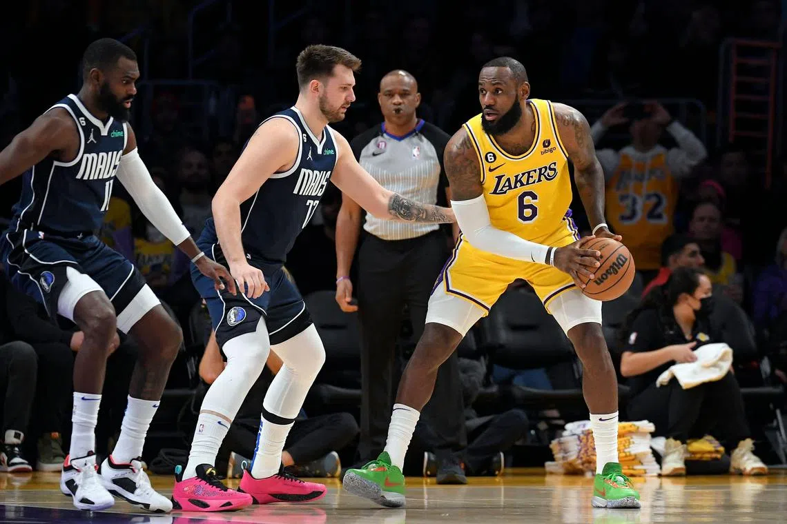 LeBron James being guarded by Luka Doncic in an NBA game in January. Los Angeles Lakers fans are anticipating the day the two superstars take to the court in the same colours after a shocking trade saw Doncic move to the team.