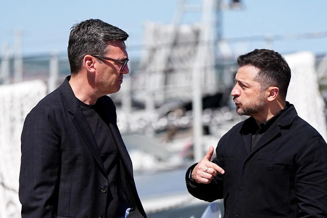 British Prime Minister Andy Burnham (left) speaks with Ukrainian President Volodymyr Zelensky at HM Naval Base in Portsmouth, Hampshire, on July 27.