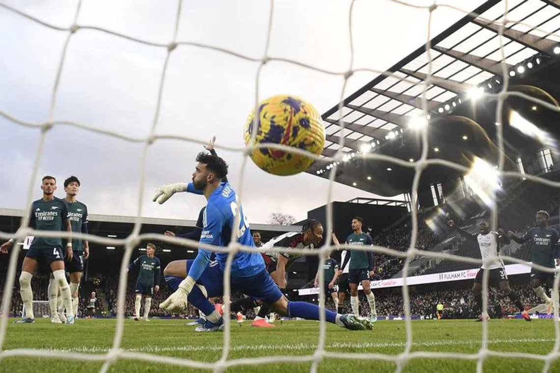 Soccer Football - Premier League - Fulham v Arsenal - Craven Cottage, London, Britain - December 31, 2023 Fulham's Bobby Decordova-Reid scores their second goal past Arsenal's David Raya REUTERS/Tony Obrien