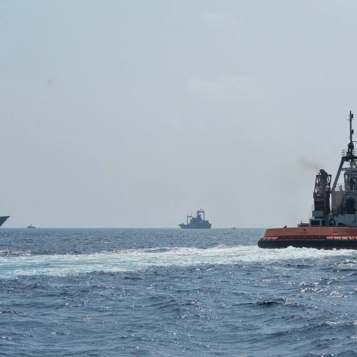 A Sri Lankan Navy tug boat and naval vessels approach an Iranian vessel during a rescue operation, a day after the crew of a distressed Iranian military ship, IRIS Dena were assisted in waters south of Sri Lanka, off the coast of Colombo, Sri Lanka March 5, 2026. Sri Lanka Navy/Handout via REUTERS