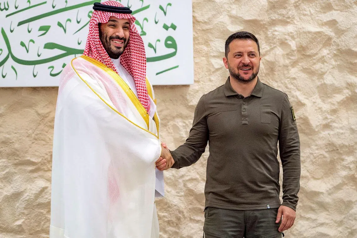 Ukraine's President Volodymyr Zelensky (right) is welcomed by Saudi Crown Prince Mohammed bin Salman to an Arab League summit in May. 