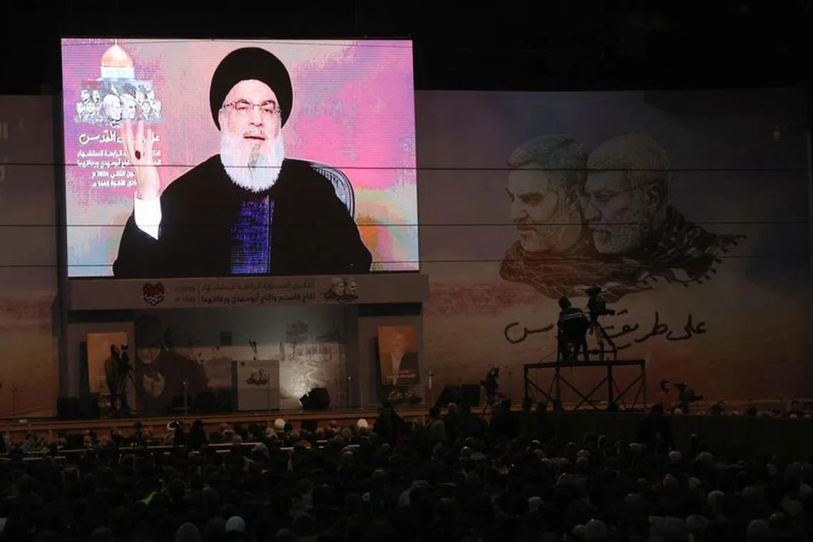 Lebanon's Hezbollah leader Sayyed Hassan Nasrallah addresses his supporters through a screen during a ceremony to mark the fourth anniversary of the killing of senior Iranian military commander General Qassem Soleimani in a U.S. attack, in Beirut's southern suburbs, Lebanon January 3, 2024. REUTERS/Mohamed Azakir