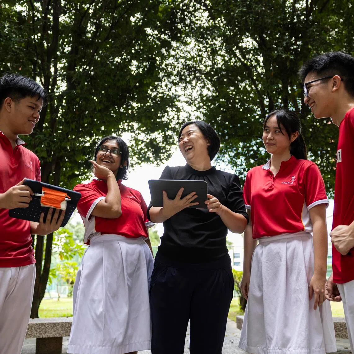 Ms Germain Kang, upper secondary year head at Fuhua Secondary School, with Secondary 4 students.
