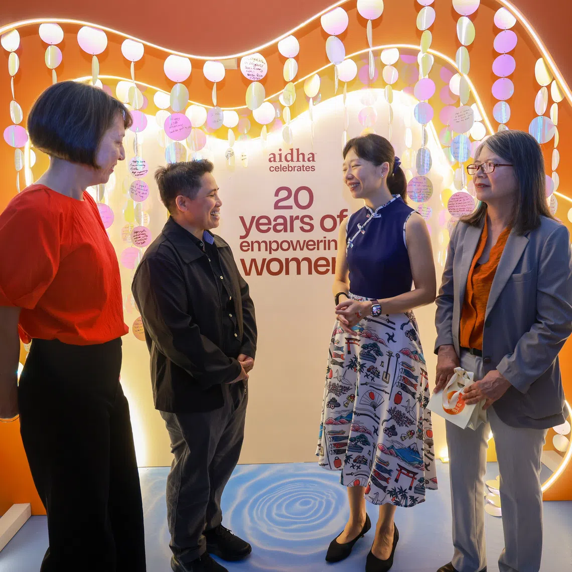 Acting Manpower Minister Jasmin Lau (second from right) alongside (from left) Aidha chair Claudine Lim, Aidha alumna Armi Sampani and Aidha CEO Jacqueline Loh on Aug 2.