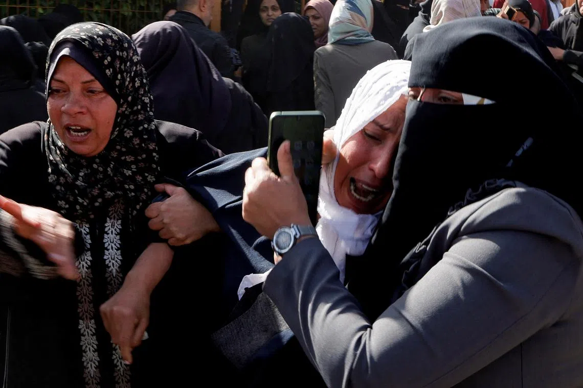 Palestinians mourn medics, who came under Israeli fire while on a rescue mission, after their bodies were recovered, according to the Red Crescent, at Nasser hospital in Khan Younis in the southern Gaza Strip March 31, 2025. REUTERS/Hatem Khaled/File Photo