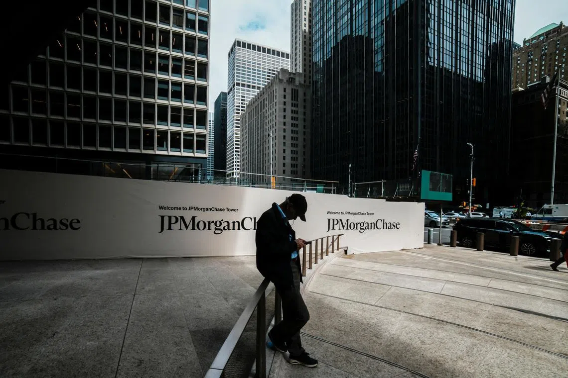 A person waits near one of the entrances of the JPMorgan Chase & Co., headquarters in New York City, U.S., April 1, 2026. REUTERS/Eduardo Munoz/File Photo