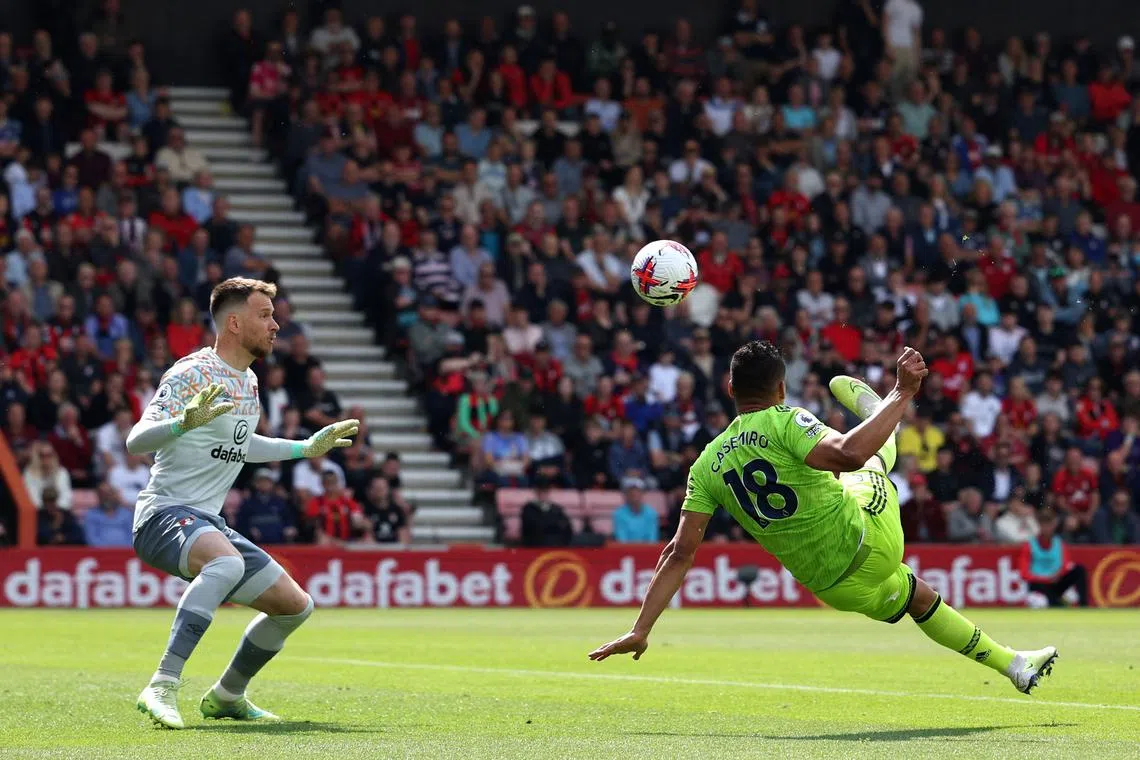 Manchester United's Brazilian midfielder Casemiro (right) scores the opening goal past Bournemouth's Brazilian goalkeeper Neto.