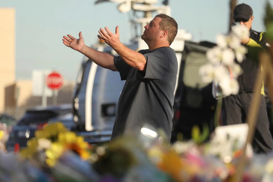 A man prays at the entrance of the Star Ballroom after a mass shooting during Chinese Lunar New Year celebrations in Monterey Park, California, U.S. on Jan 24, 2023. 