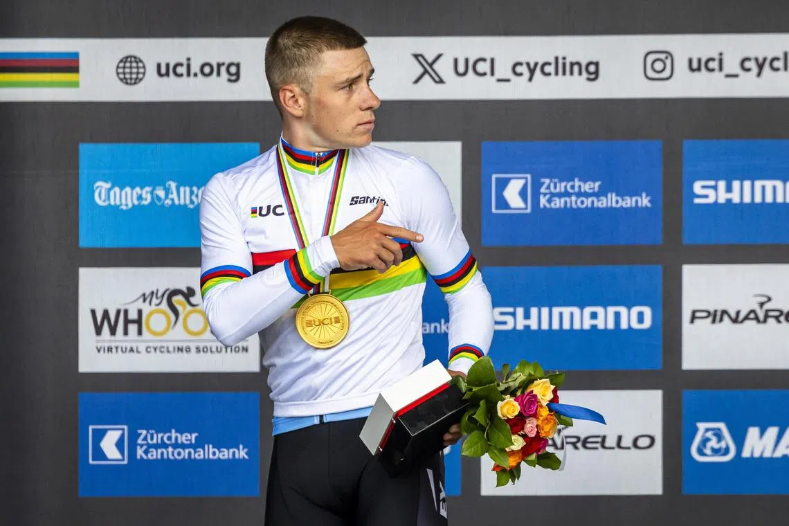 Gold medallist Remco Evenepoel of Belgium gestures on the podium after winning the world time-trial title.