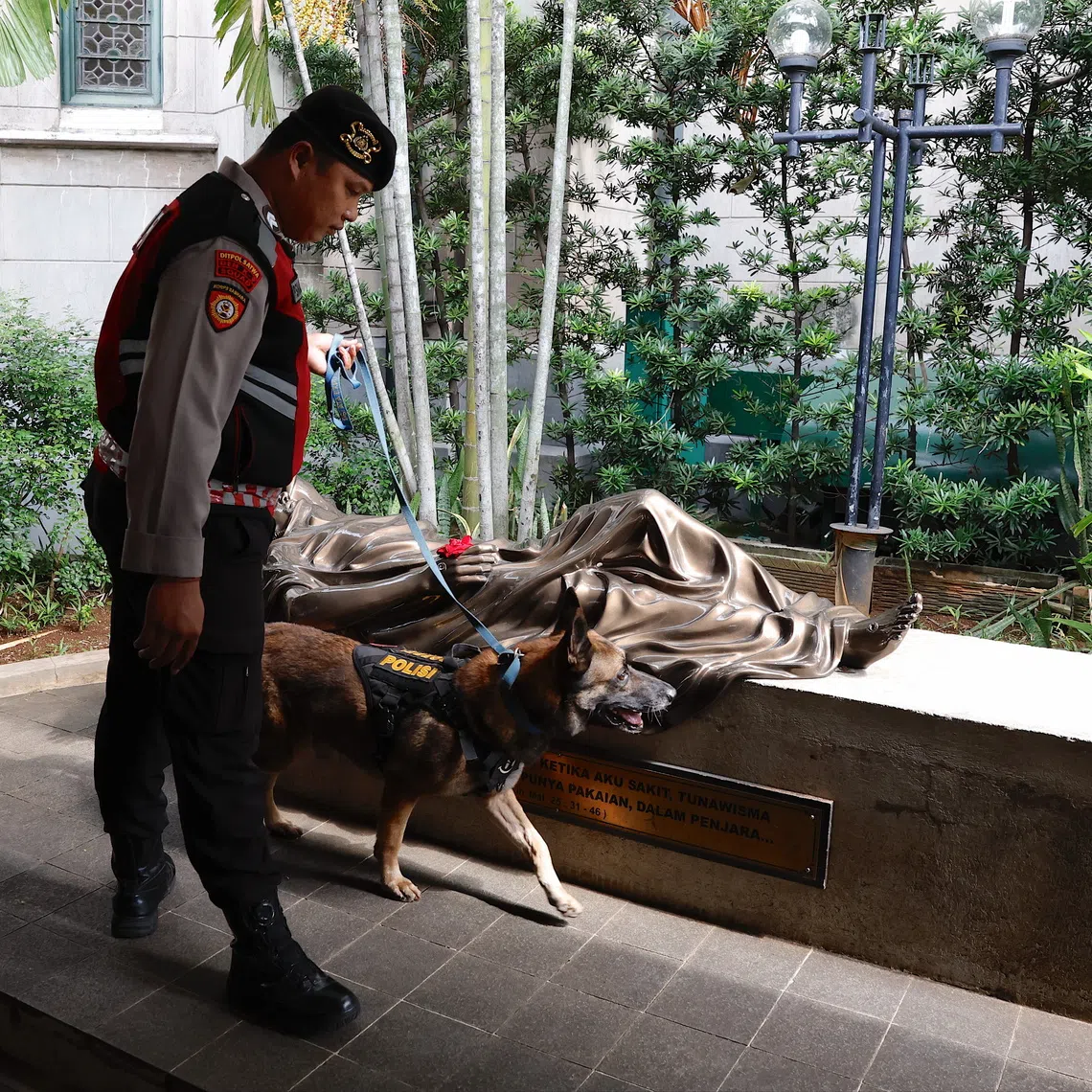 An H-9 police officer inspects the area ahead of Christmas celebrations at the Cathedral of Our Lady of the Assumption in Jakarta on Dec 23.