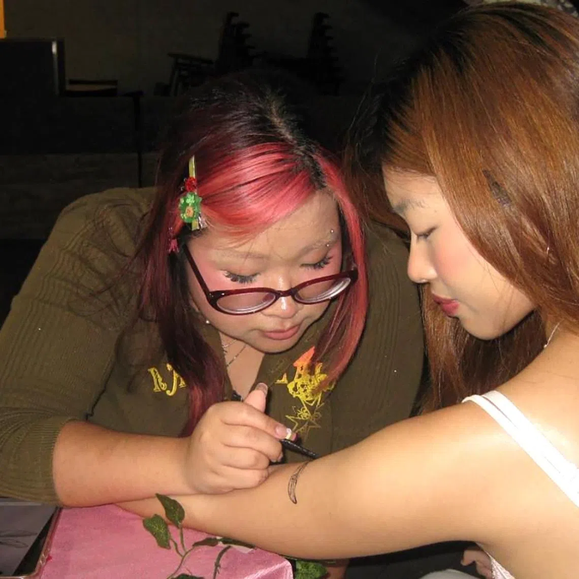 Nikita Ria Jei Siregar, 21, draws a jagua tattoo on a customer’s arm at Hammock Market on April 4.