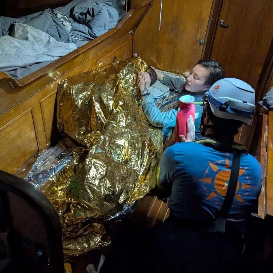 A Compass Collective volunteer assists an eleven-year-old girl from Sierra Leone, the sole survivor of a shipwreck off Italy's Lampedusa Island, on board of rescue vessel Trotamar III in this handout picture released on December 11, 2024. Compass Collective/Handout via REUTERS