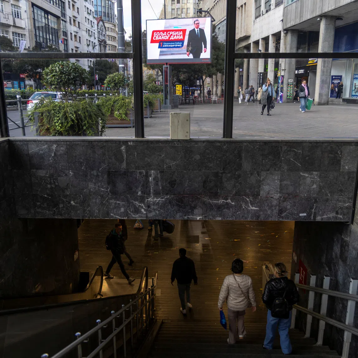 People walk in the underpass past an electoral poster of Serbia's former President and the ruling Serbian Progressive Party (SNS) candidate for Prime Minister Aleksandar Vucic in Belgrade, Serbia, October 16, 2026. REUTERS/Djordje Kojadinovic