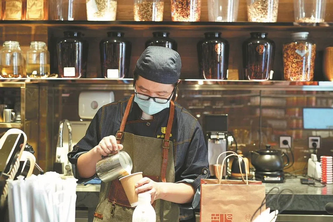 Named Herbal Coffee, the shop is a magnet for young consumers streaming in on a hot summer’s day to have a swig of its famous TCM-flavored brew.