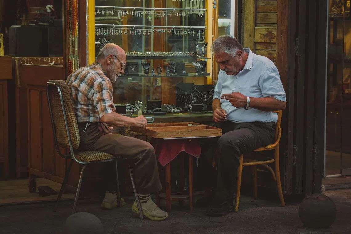 A game of backgammon outside a store in Damascus, Syria. Tourist numbers in Syria more than doubled year-on-year in the first half of 2026 to 3.52 million.