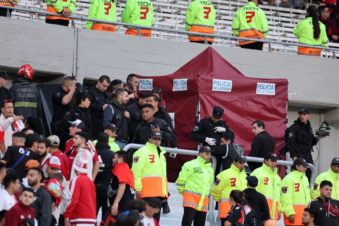 Police and firefighters work at the site where a spectator fell from the top of a grandstand during the 2023 Argentine Professional Football League Tournament match between River Plate and Defensa y Justicia at the El Monumental stadium, in Buenos Aires, on Saturday. 