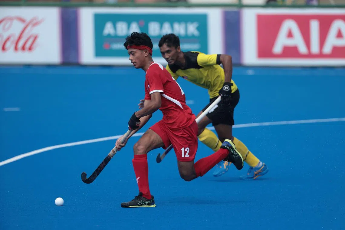 Singapore's Nufail Raiyan Abu Bakar in action against Malaysia's during the men's hockey final on Tuesday. Malaysia won 3-0. 