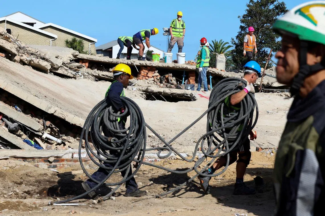 FILE PHOTO: Rescuers work to rescue construction workers trapped under a building that collapsed in George, South Africa May 8, 2024. REUTERS/Esa Alexander/File Photo