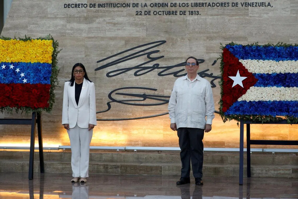 FILE PHOTO: Venezuela's interim president Delcy Rodriguez and Cuban Foreign Minister, Bruno Rodriguez Padilla attend the ceremony \"Promotions and Decorations for Heroes and Martyrs\", honouring Venezuelan and Cuban military and security personnel who died during a U.S. operation to capture Venezuela's President Nicolas Maduro and his wife Cilia Flores, in Caracas, Venezuela January 8, 2026. REUTERS/Leonardo Fernandez Viloria/File Photo